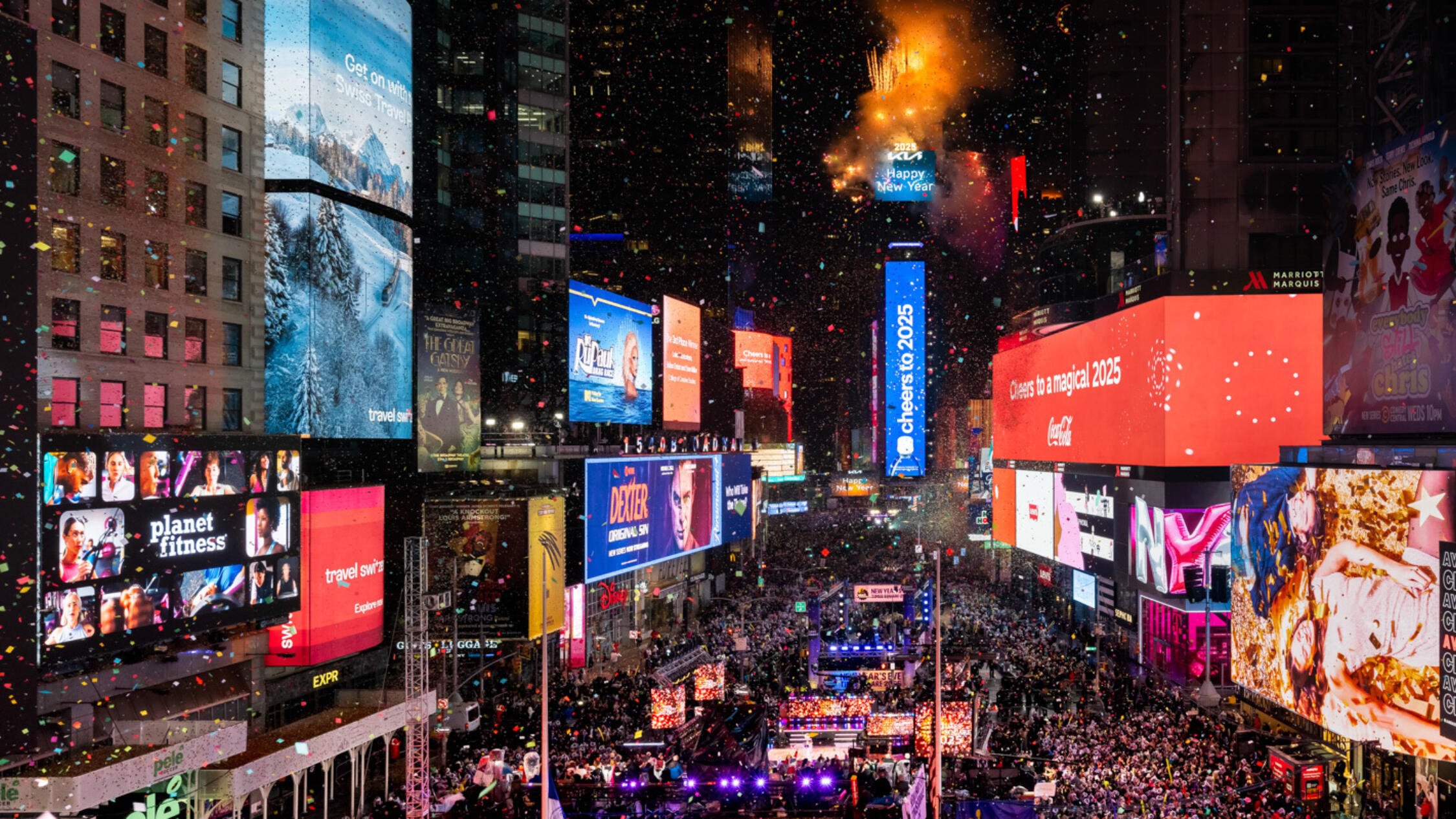 Massive crowd in Times Square for New Year's Eve 2025 celebration with Ball Drop and fireworks atop the One Times Square building