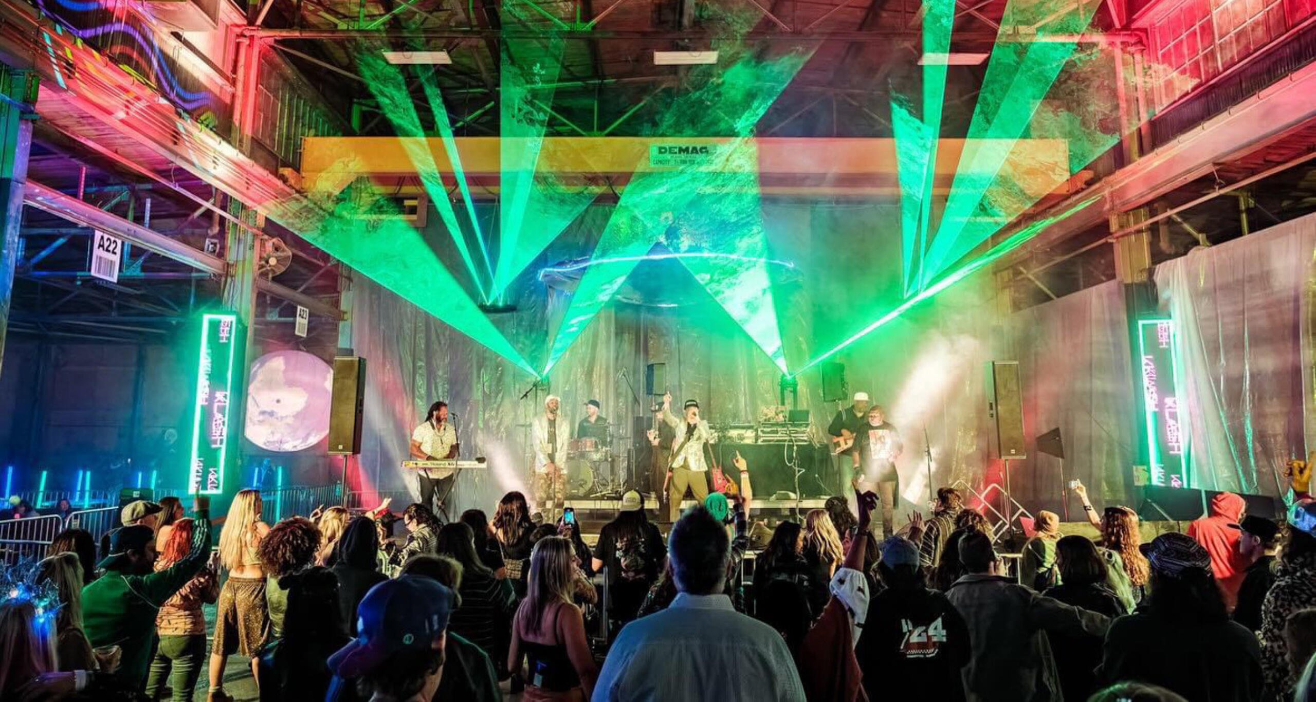 A crowd of people watching live music on a stage at the Kulture Klash festival at Navy Yard Charleston