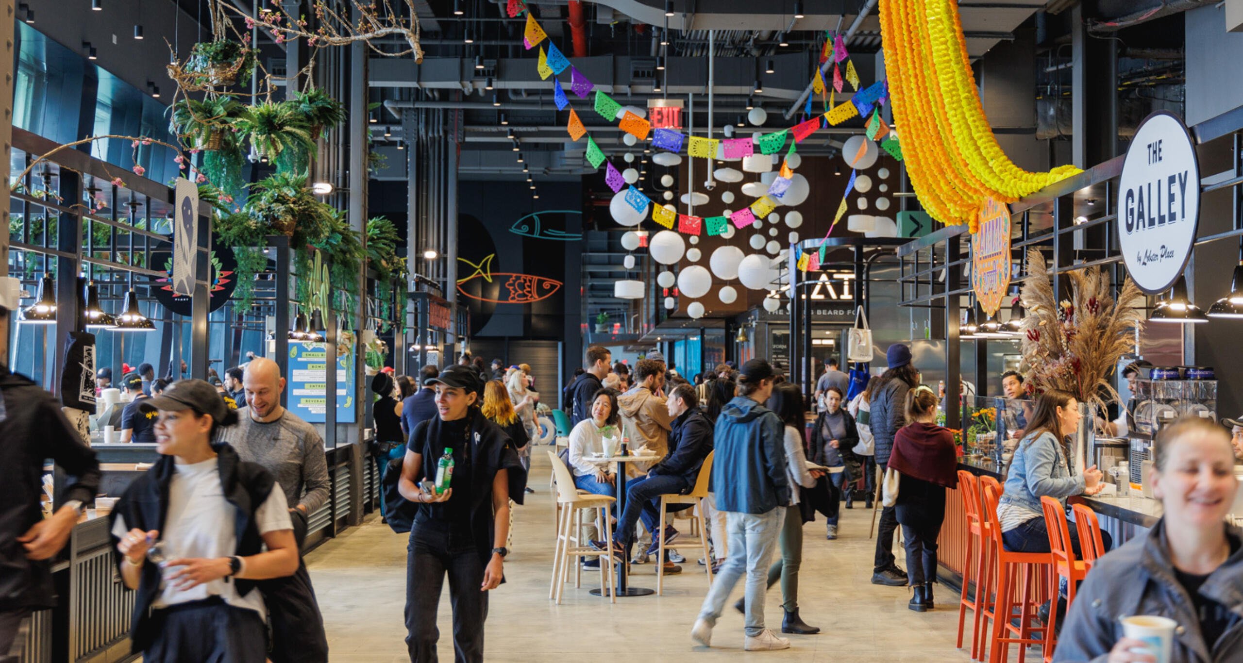 Visitors exploring the Market 57 food hall inside Pier 57