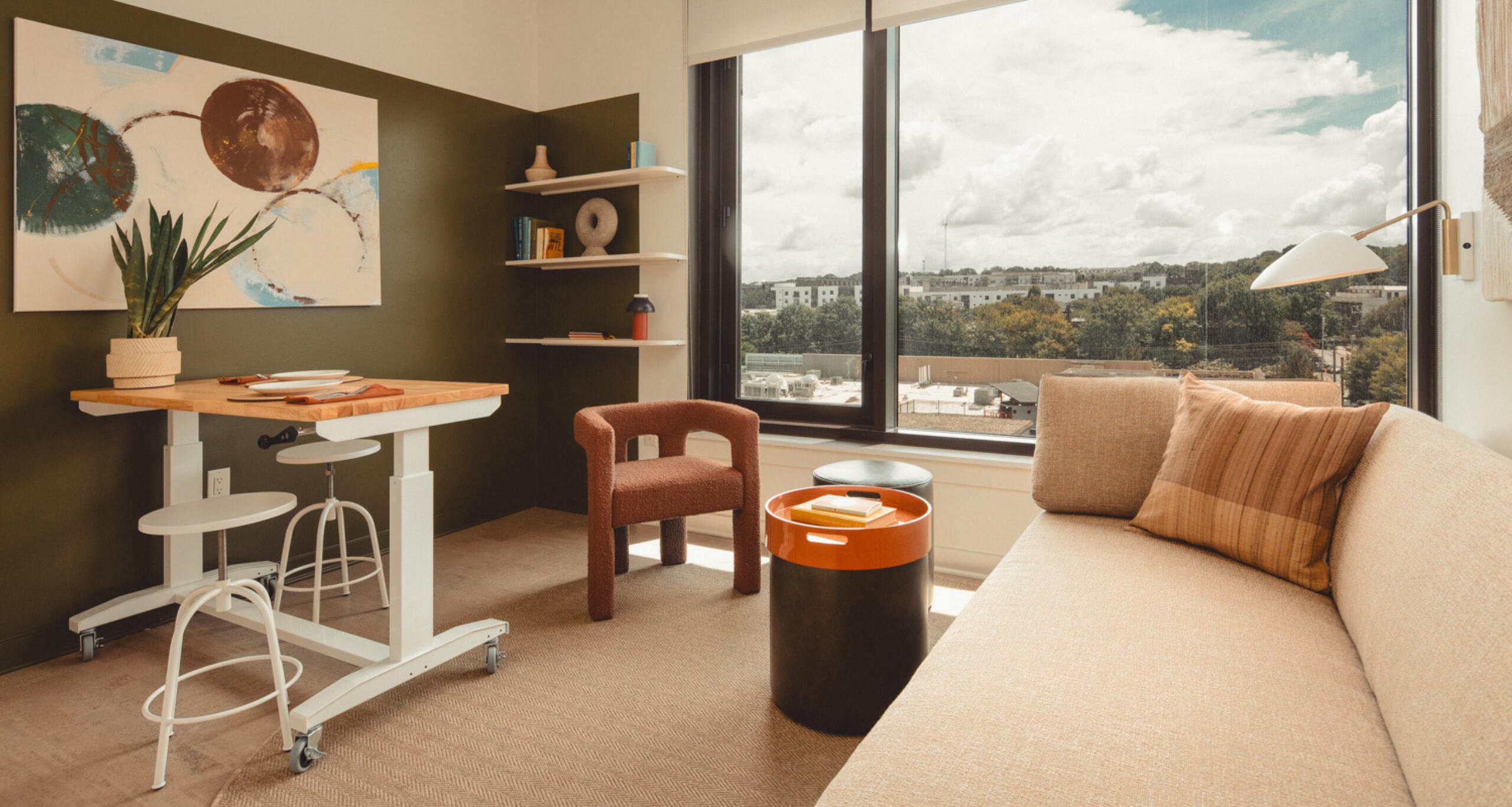 Inside a guest suite at Scout Living with the Atlanta skyline visible outside the window