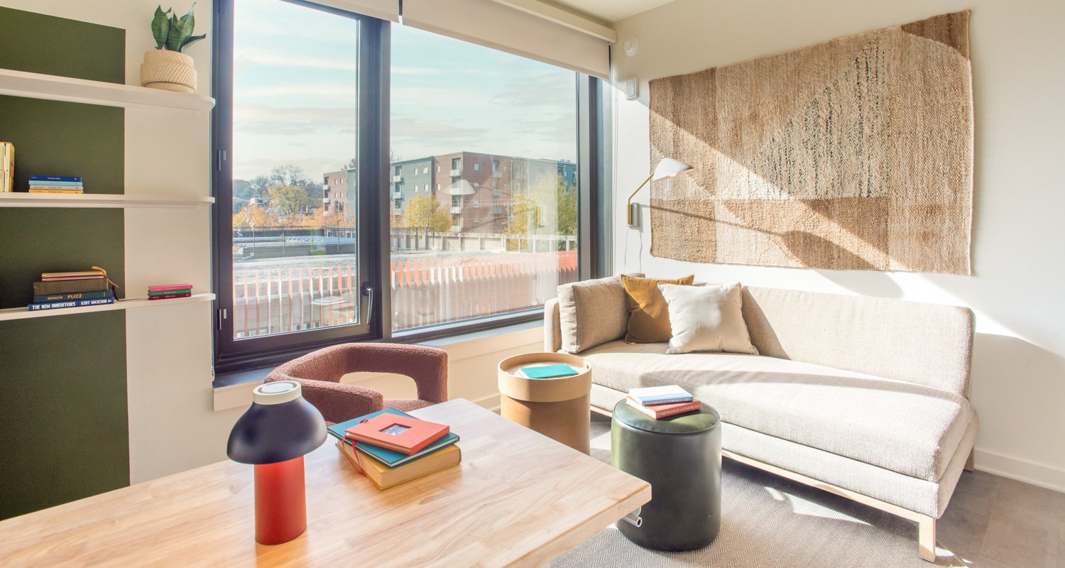 Interior of unit at Scout Living with buildings visible through window